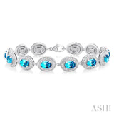 7x5 MM Oval Shape Blue Topaz and 1/10 ctw Round Cut Diamond Semi Precious Bracelet in Sterling Silver